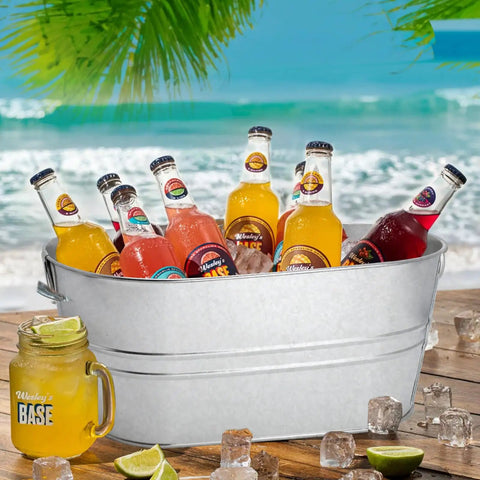 Two Pack Four Gallon Galvanized Ice Buckets With Handles For Parties Portable Beverage Tub Keep Bottles Cans And Ice Chill At Any Event Includes Ice Scoop For Easy Ice Refill And A Durable Metal Tub filled with assorted bottled drinks on a beach setting