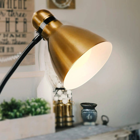 Close-up of brass finish dimmable floor lamp with sturdy base for over chair reading, adding modern elegance to home decor.