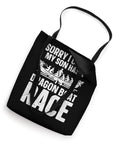 Black dragon boat race tote bag with humorous text printed on the front, featuring sturdy straps, perfect for crew gear and practice.