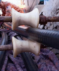 Heavy Duty Cable Pulley Sheave For Large Scale Wiring Projects And Industrial Laying Built Tough With High Load Smooth Pulling Wire Pulling Sheave 7x8 Pulleys For Construction And Tunnel Installations, showing a heavy-duty cable resting on a dual sheave system in use at a construction site.