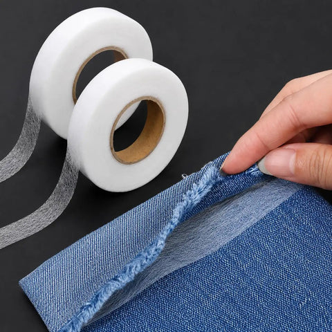 One Inch By Two Hundred Ten Feet Iron On Hemming Tape Double Sided No Sew Hem Tape used on denim fabric close-up