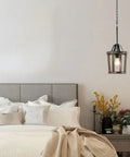 Dope Farmhouse Oak Wood Island Pendant Light with Bronze Finish over bedside, features 59 inch chain, E26 socket in bedroom.