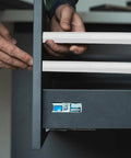 Person installing Premium Nine Inch Plastic Drawer Slides, Four Pack Side Mounted Guide Rails With Screws on a drawer.