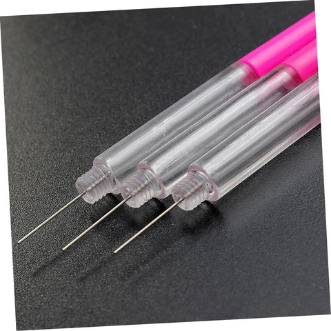 Close-up of transparent and pink Precision Oiler Pen For Watch Repair And Clock Work Pro Grade Oil Tool with fine tips