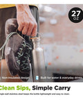 27 Oz Brushed Stainless Steel Water Bottle With Bamboo Lid Leak Proof Reusable Drinkware held by a person with climbing shoes.