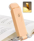 USB Rechargeable Clip On Reading Light With Amber And Warm White Modes, Eye Friendly Dimmer, Peach Fuzz Color on book