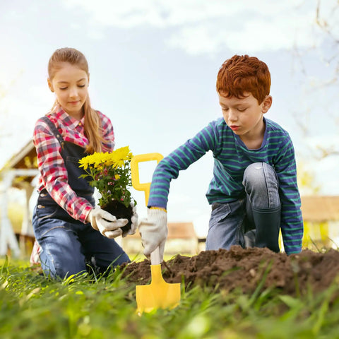 Children gardening with yellow shovel from Four 16 Inch Multicolor Beach Shovels With Wooden Handles Durable Plastic Sand Spades.