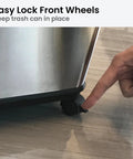 Person demonstrating locking feature on set of four caster wheels for glide trash cans and garbage bins with wheels.