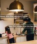 Person using Crazy Bright Supercolor BR30 Smart Flood Bulbs 2 Pack with voice commands in a modern kitchen setting.
