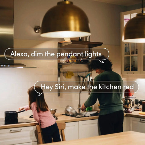 Person using Crazy Bright Supercolor BR30 Smart Flood Bulbs 2 Pack with voice commands in a modern kitchen setting.