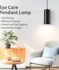 Sleek 4 Inch Led Pendant Lights, 25W Cylinder Hanging Fixtures With Dip Switch, Modern Eye Care Indoor Ceiling Lamps For Kitchen Island Flex Zone Or Home Office Setup In Matte Black 2 Pack above a cozy chair.