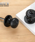 Matte Black Interior Door Knob With Lock For Privacy, Coastal Style Door Handle With Round Rosette, Zinc Spindle On Wood Surface