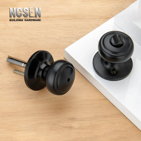 Matte Black Interior Door Knob With Lock For Privacy, Coastal Style Door Handle With Round Rosette, Zinc Spindle On Wood Surface