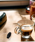 Glass of espresso beside Espresso Steam Wand Heat Insulation Sleeve Anti Burn Rubber Wrap For Coffee Machines Easy To Install.