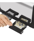 Hand removing crumb tray from 4 Slice Toaster With Dual Control, Bagel, Reheat And Defrost Settings, 850 Watt Black And Silver Finish