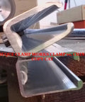 Side view of 24 Inch Adjustable Bar Clamp Set For Woodworking Four Pack Pro Grade Heavy Duty Clamps with notched bars on workbench.