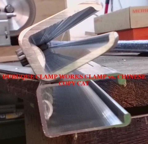 Side view of 24 Inch Adjustable Bar Clamp Set For Woodworking Four Pack Pro Grade Heavy Duty Clamps with notched bars on workbench.