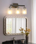 Three Light Brushed Nickel Vanity Light With Frosted Glass Shades, Wall Mount Sconce over bathroom mirror, modern lighting setup