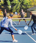 Players using Lightweight Fiberglass Pickleball Paddles Set Of 2 With Honeycomb Core And Grippy Handle For Superior Spin And Control in a match.