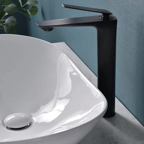 Close-up of Large Oval Vessel Sink 24 Inch By 13.8 Inch White Ceramic Above Counter Bathroom Sink With Pop Up Drain beside faucet
