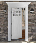 Open stone-framed entryway with white door partially open, showcasing exterior door knob with lock in satin nickel finish.