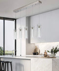 Modern Five Light LED Pendant Ceiling Fixture With Brushed Nickel Bubble Cylinder in a sleek kitchen setting
