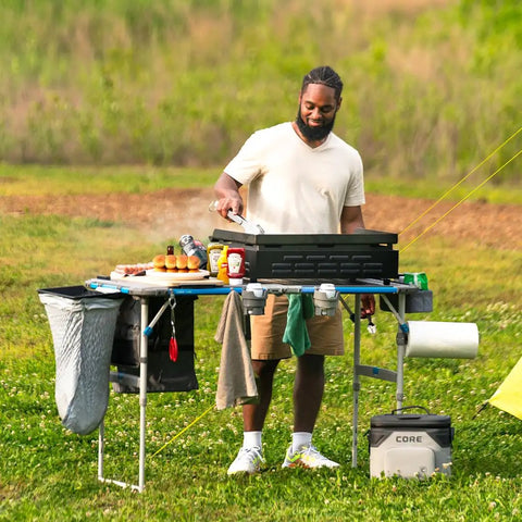 Man using Hanging Organizer For Outdoor FlexRail Camp And Cook Table, durable weather resistant pocketed storage, outdoor cooking