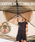 Man setting up 13 By 13 Pop Up Gazebo With Mosquito Netting Centerlok Six Sided Portable Canopy using center lock technology