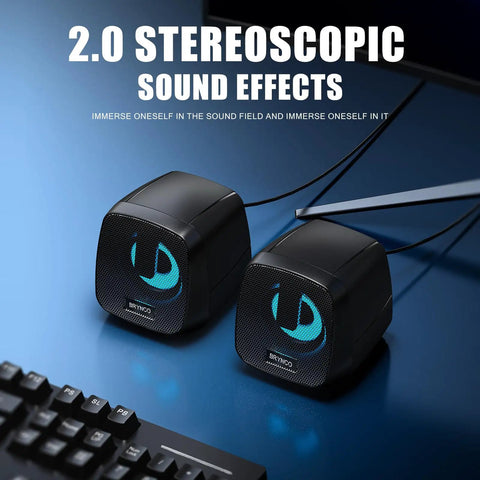 2.0 Stereo USB Powered Desktop Speakers With 3.5mm AUX In Line Volume Control And LED Lights on a desk next to monitor