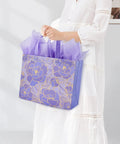 Person holding purple Two Pack 13 Inch Large Gift Bags Set With Greeting Card And Tissue Paper Reusable Nonwoven Gift Wrap Bags With Handles