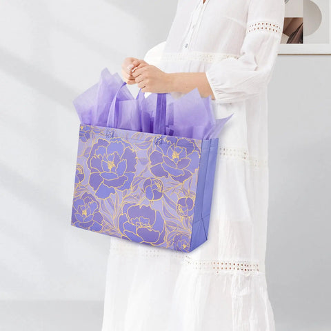 Person holding purple Two Pack 13 Inch Large Gift Bags Set With Greeting Card And Tissue Paper Reusable Nonwoven Gift Wrap Bags With Handles