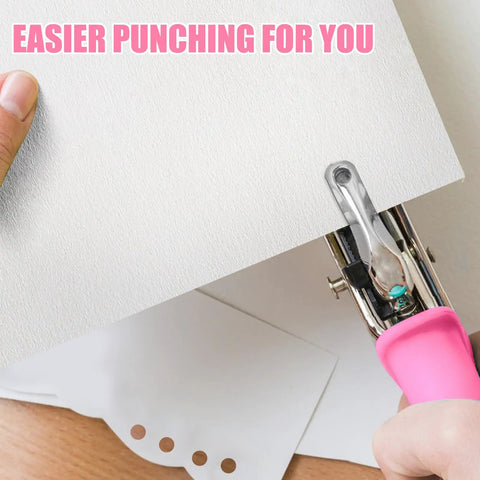 Two Hole Punch Set With Quarter Inch And Eighth Inch Holes, pink soft grip punch in use on white paper