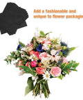 Bouquet wrapped with 10 Piece Floral Embossed Kraft Paper Sheets With Polka Dot Texture For Bouquet Wrapping next to black sheets