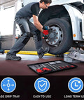 Mechanic using Triple Pack Extra Large Oil Drip Pan 35.4 X 24 Inch Heavy Duty Plastic Drain Tray under truck with tools and gloves.