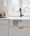 Kitchen with Vintage Western Horsehead Drawer Pulls Set Of 6 Hand Painted Resin Cabinet Knobs on white cabinets under a window.