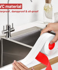 Applying Caulk Tape Self Adhesive Sealant Strip Waterproof 1.5 Inch By 10.5 Foot to kitchen sink edges.