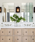 Set Of Two Farmhouse Wall Sconces With Modern Industrial Vibe, Matte Black Finish And Faux Wood Backing in bathroom setting