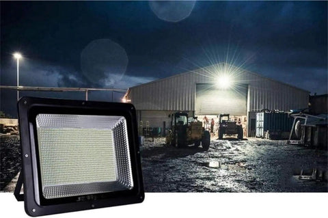 Led Flood Light, IP66 Waterproof Super Bright Security Lights illuminating outdoor work area at night with machinery nearby.