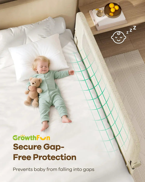 Toddler sleeping safely beside a Foldable Toddler Bed Rail 59 Inch Reinforced Carbon Steel Frame With Connectors, cream color.