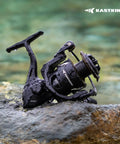 Spartacus II Plus Spinning Reel For Freshwater And Saltwater Angling, IPX5 Waterproof, on a wet rock by the water.