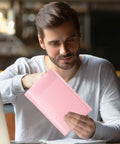 Man holding 6X10 Inch Light Pink Bubble Mailers 25 Pack Self Seal Padded Poly Mail Bags For Small Business Chic Opaque Matte Shipping Envelopes