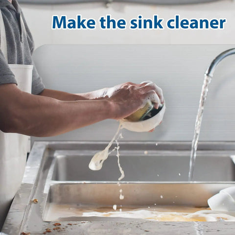 Person washing dishes in a sink with a Stainless Steel Sink Splash Guard Wall Mount With Screws 17 By 12 Inch Heavy Duty Rustproof Corner Guard visible.