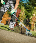 Person using a 63 Inch Long Handle Rotary Tiller For Easy Gardening Adjustable From 25 To 63 Inches Aluminum Detachable Tines on grass