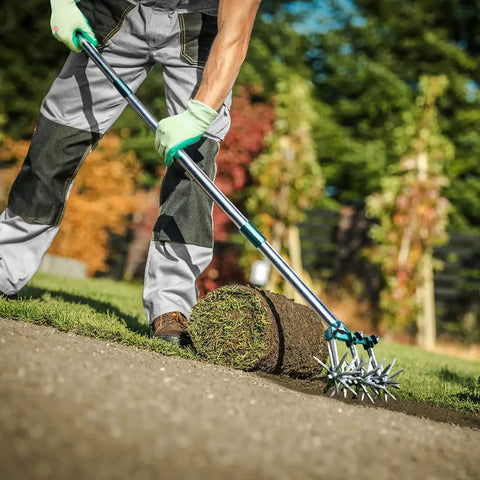 Person using a 63 Inch Long Handle Rotary Tiller For Easy Gardening Adjustable From 25 To 63 Inches Aluminum Detachable Tines on grass