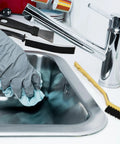 7 Piece Multi Purpose Crevice Cleaning Brush Set in use with sink and grey gloved hand wiping with cloth