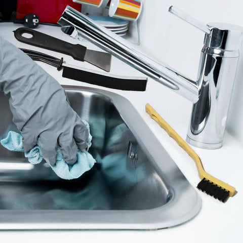 7 Piece Multi Purpose Crevice Cleaning Brush Set in use with sink and grey gloved hand wiping with cloth
