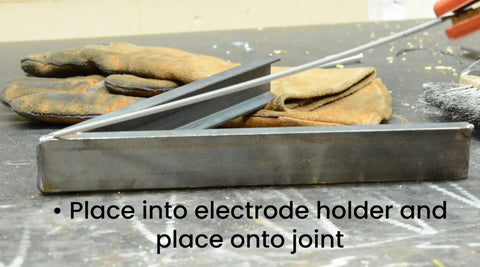 5 64th Inch E6013 Arc Welding Electrodes, 5 Pound Pack, All Purpose Welding Rods For Mild Steel, Easy To Start At Low Amps, Works In All Positions, 60,000 PSI Weld Strength, Best On Clean Light Gauge Metal, Great For Beginners To Pros. Steel welding rods in electrode holder on joint