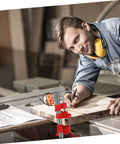 Woodworker using a Lightweight Quick Woodworking Pipe Clamp With Ergonomic Grip For One Hand Operation on a wooden board in a workshop