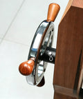 Close-up of the handwheel from a Heavy Duty Woodworking Leg Vise Kit With Inertia Driven Handwheel For Quick Open Close Strong Parallel X Bracket Adjustable Workbench Clamp For Carpentry Furniture Making And DIY Workshop Projects.