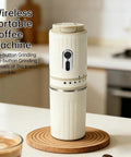 Score Fresh Sips Anywhere With This Ride Or Die Travel Coffee Maker Featuring A Compact Built In Grinder And Heat Proof Tumbler Perfect For Commuting Hiking Or Just Chilling At Home, showing a white wireless portable coffee machine on a wooden coaster.